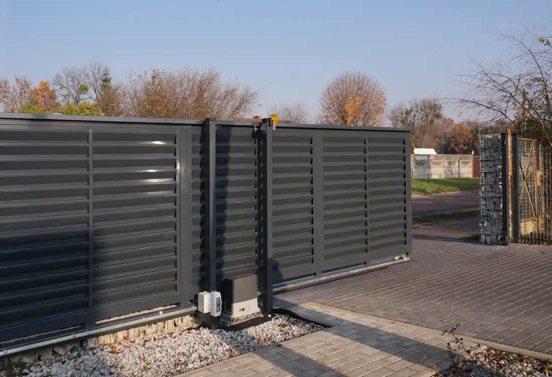 Horizontal slat driveway gate matching a modern fence line