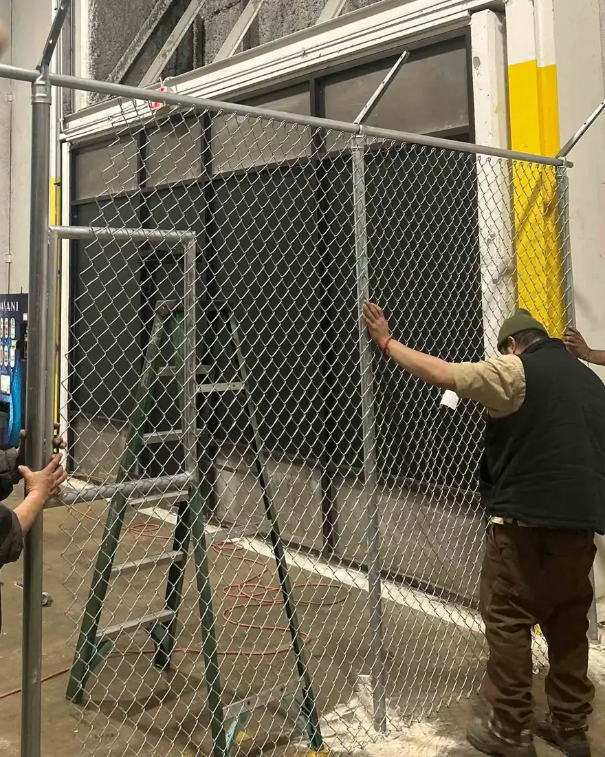 Crew setting posts for a new chain link fence