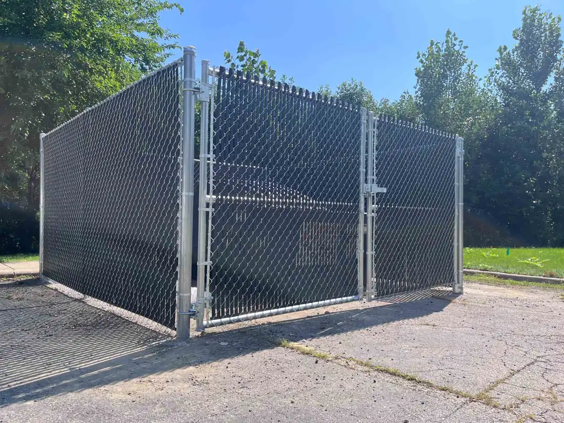 Chain link rolling gate at a commercial service entrance