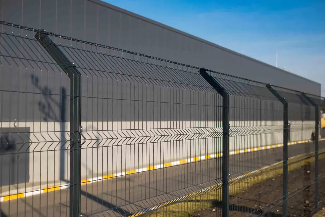 Black welded mesh security fence around a commercial property