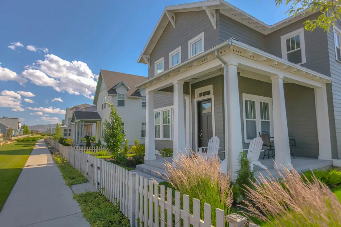 Picket fence lining a sidewalk in a residential neighborhood