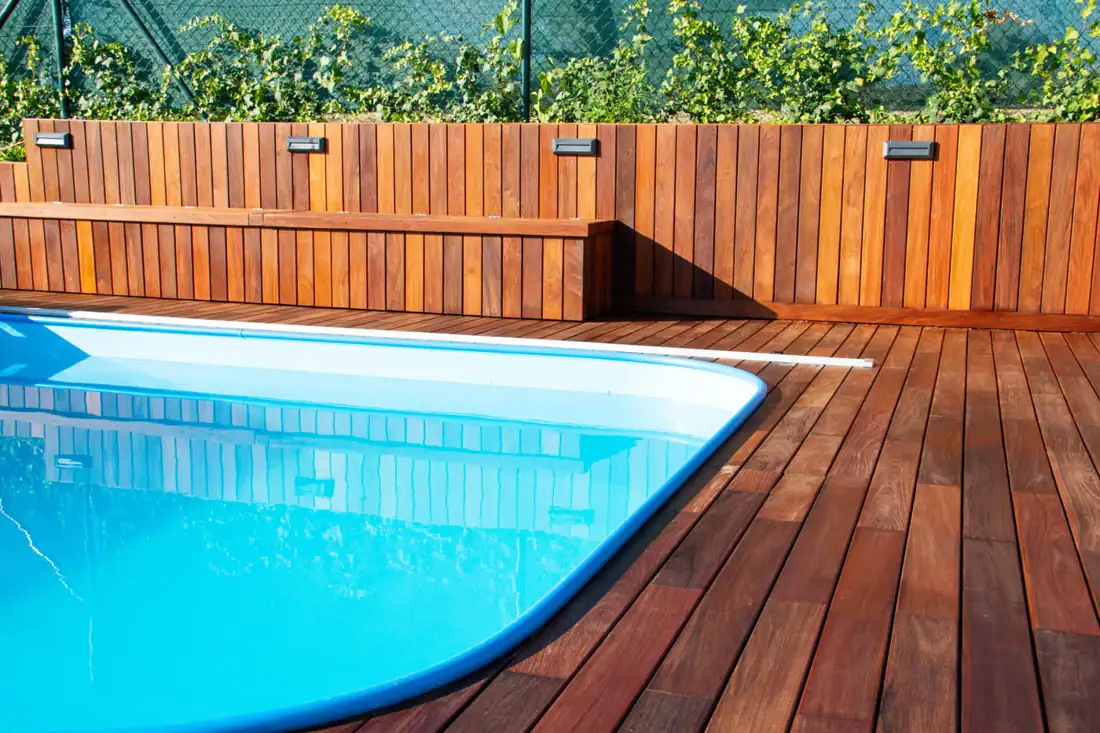 Wood privacy fence around a pool deck